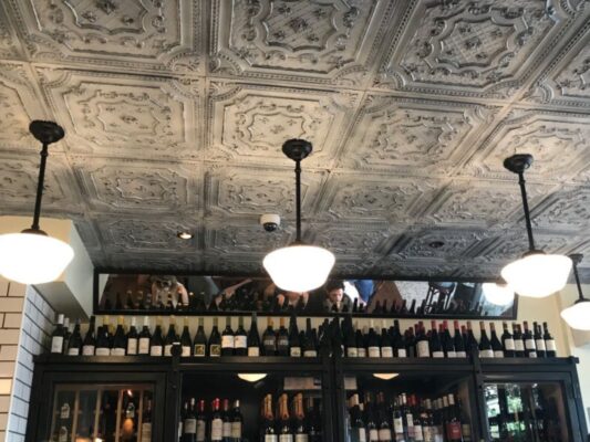faux tin ceiling tiles installed in bar