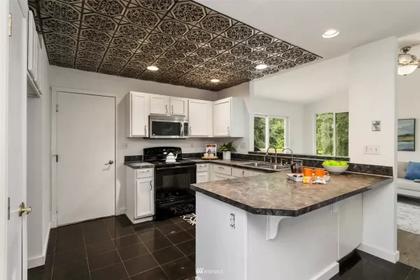 homeowner adds ceiling tiles to kitchen
