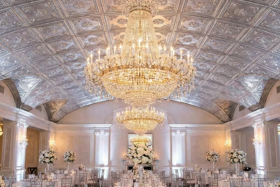 Luxury wedding banquet hall featuring shimmering silver 3D PVC ceiling tiles.