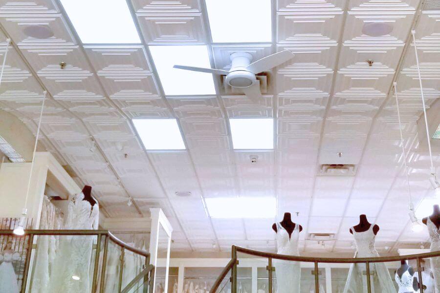 bridal boutique ceiling design Luxury ceilings for wedding salons featuring white decorative tiles and elegant mannequins.