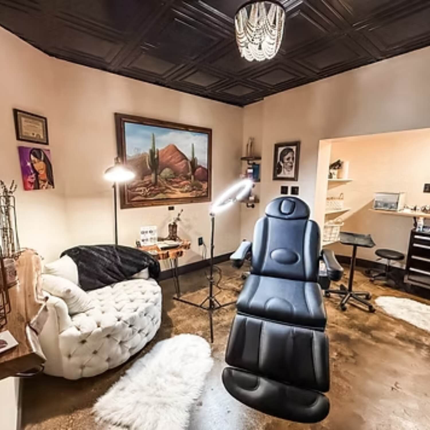 aesthetic clinic treatment area enhanced by decorative black faux tin ceiling tiles and eclectic decor.