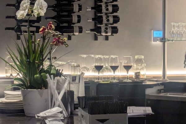 Elegant restaurant wine rack setup in Sacramento, CA, highlighting the sophisticated interior finished with high density crown molding.