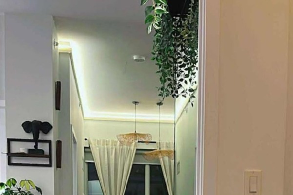 Hallway view of a contemporary Toronto condo utilizing 04-903 polymer crown molding to create seamless and warm LED cove lighting.