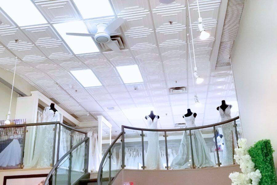 luxury wedding salon ceiling Faux tin bridal boutique ceiling design with bright lighting and modern ceiling fans.