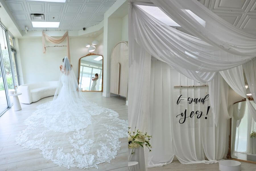 luxury wedding salon fitting Bride trying on a long train wedding dress under a decorative luxury ceiling.