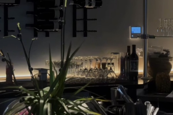 Dark and moody bar area in a Sacramento restaurant enhanced by elegant high density polymer crown molding and subtle ambient lighting.