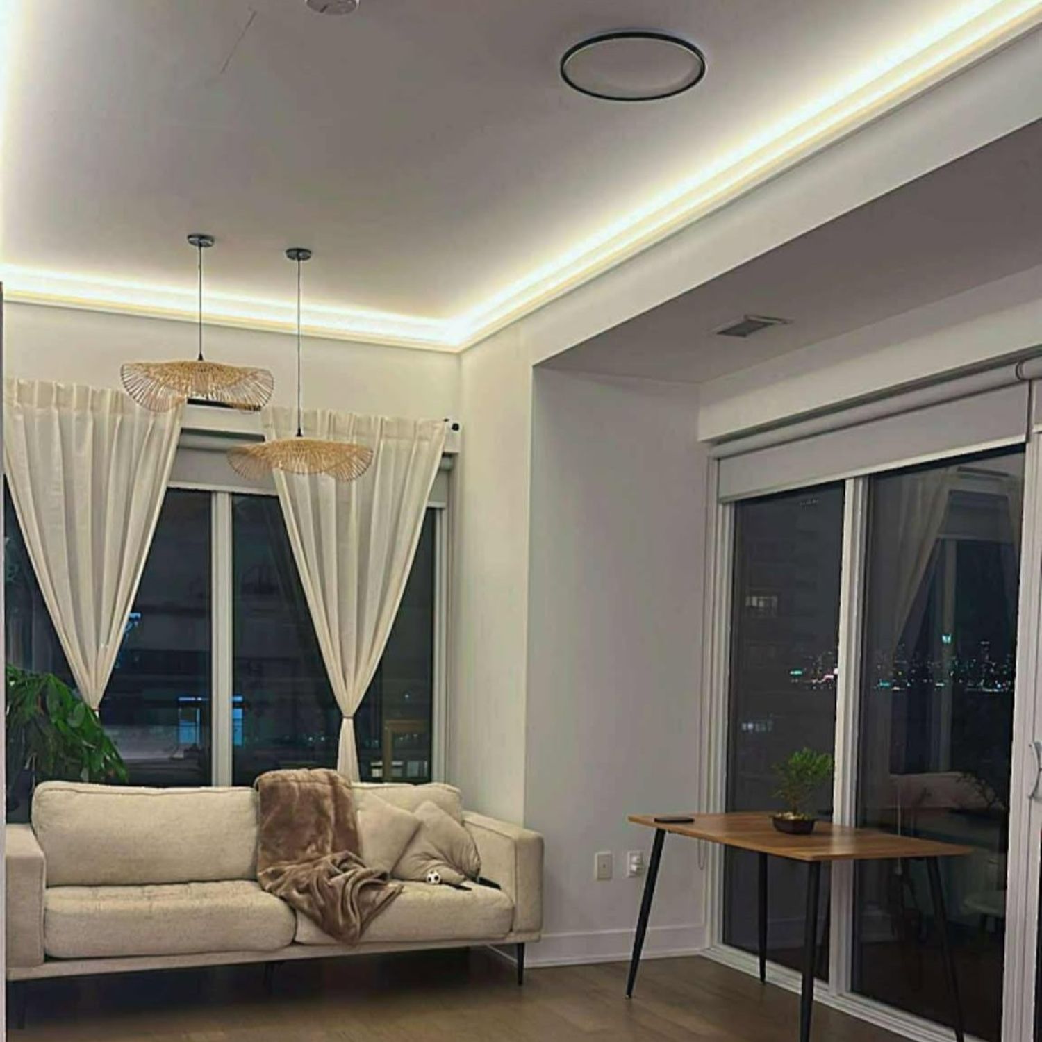 Modern Toronto condo living room featuring beautiful indirect LED ceiling lighting integrated with high density polymer crown molding.