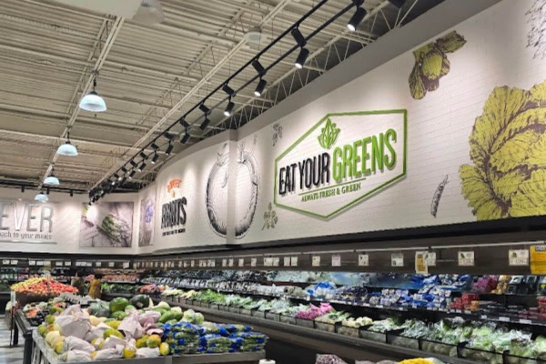 Commercial white faux brick panels installed above fresh produce displays at Lotte Market in Catonsville, Maryland.