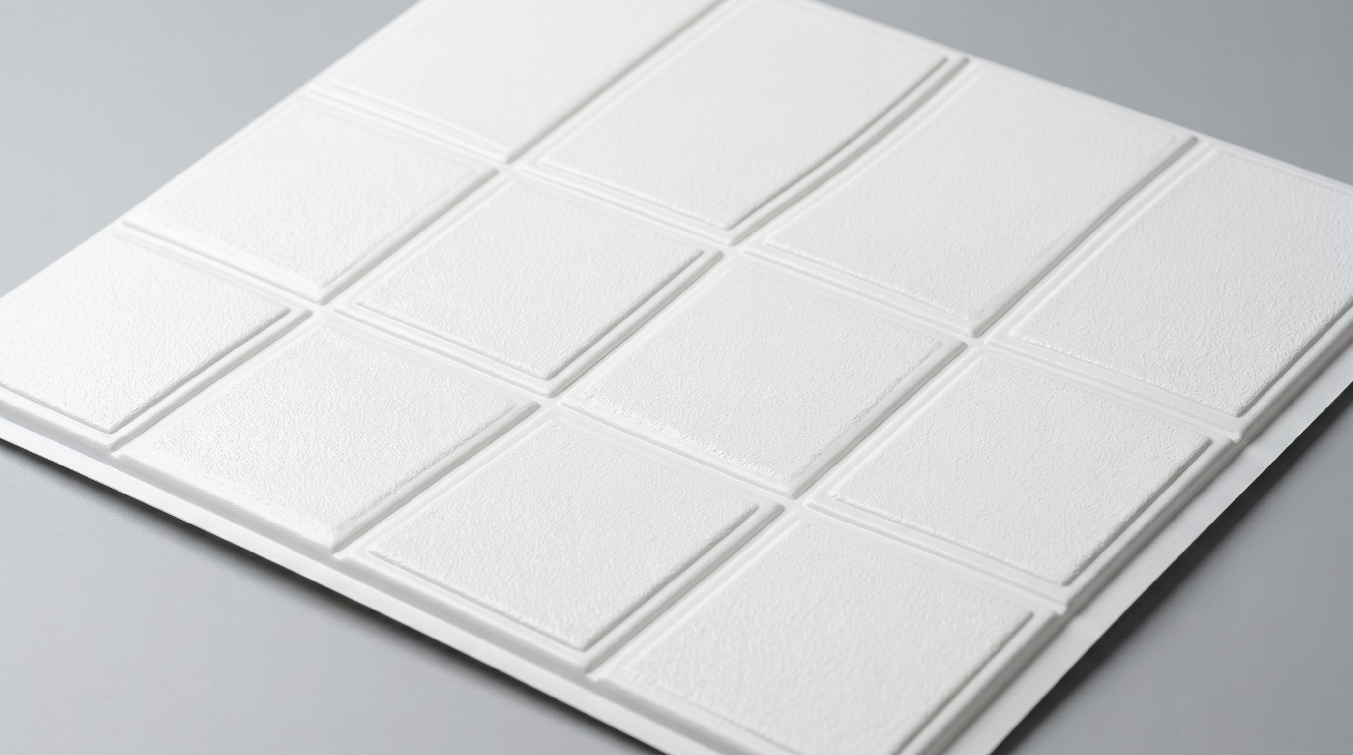 White PVC ceiling panel with embossed tile pattern for lightweight home or RV ceiling installation