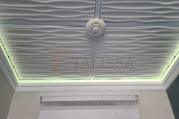 A modern room upgrade featuring an illuminated 3D wave ceiling framed by 04-915 High Density Polymer Crown Molding with ambient green LED lighting.