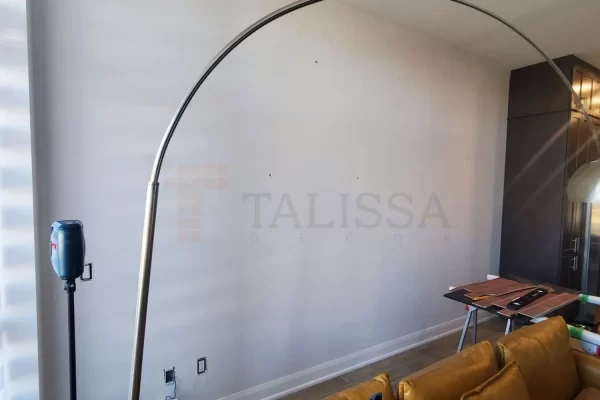 Before photo of a blank white family room wall in an Oakville house, ready for a DIY faux brick installation.