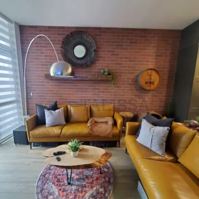 Talissa Decor Faux Bricks Wall Panels 112 installed as a stunning brown accent wall behind a yellow couch in an Oakville family room.