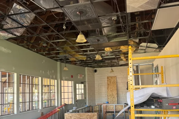 Exposed ceiling and construction phase inside a commercial coffee space before installing decorative PVC ceiling tiles in Novato, CA.