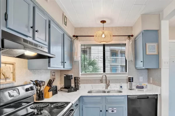 Close-up view of lightweight styrofoam ceiling planks installed effortlessly around light fixtures in a beach house kitchen.