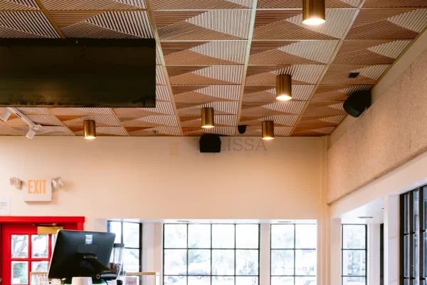 Cozy window seating area in a Novato cafe, enhanced by the striking design of a hypnotic triangle patterned ceiling.