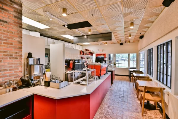 Bright, modern interior of Equator Coffees featuring our 362 Hypnotic Triangles Faux Tin Ceiling Tiles over the main serving counter.