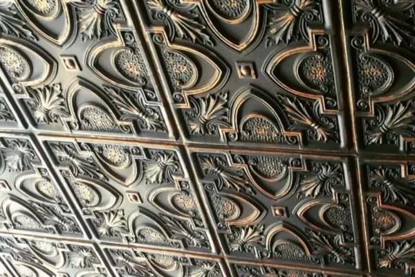 Close-up of the TD11 Victorian Tin Ceiling Tiles showing intricate vintage details and the beautiful smoked copper finish.