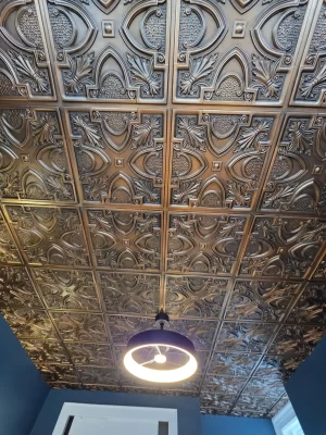 Close-up detail of the intricate Victorian pattern on the TD11 faux tin ceiling tiles in aged copper.
