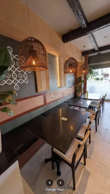 Commercial dining room showcasing a seamless installation of rustic faux wood beams over the seating area.