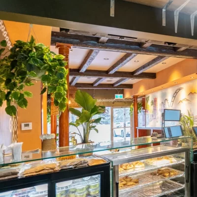 Restaurant ordering counter framed by sophisticated dark walnut faux wood beams overhead.