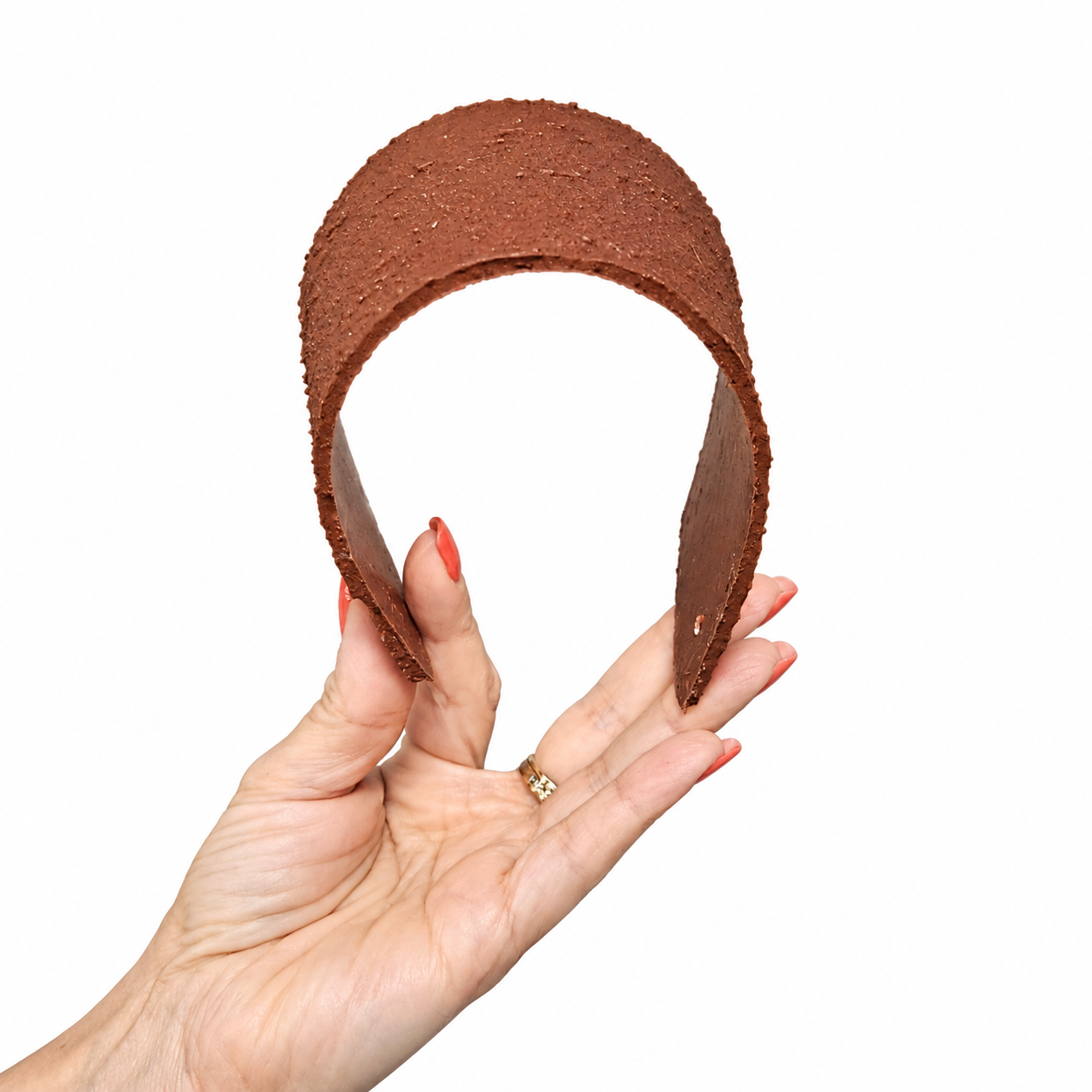 Hand Displaying Textured Brown Arch