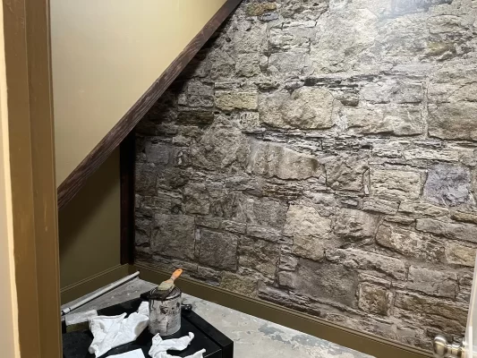 MU1458 Castle Stones mural hung under a staircase slope in a Toronto, ON home, freshly installed