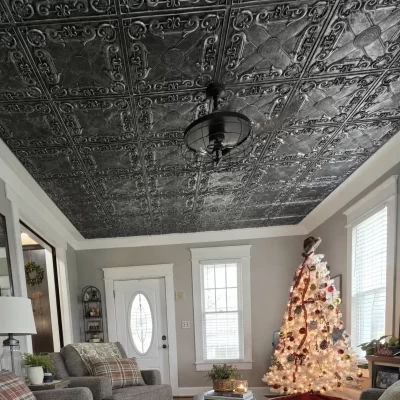 Living room in Grand Rapids, OH with a full ceiling of TD22 Aged Silver faux tin tiles, white crown molding and a black caged ceiling fan