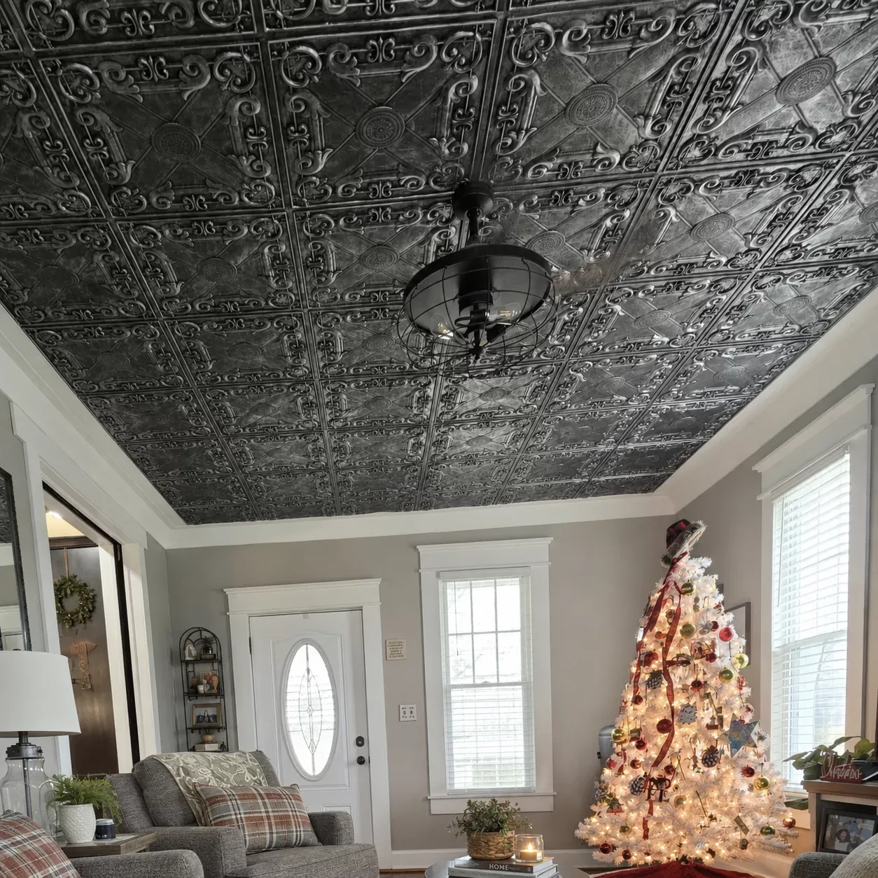 Living room in Grand Rapids, OH with a full ceiling of TD22 Aged Silver faux tin tiles, white crown molding and a black caged ceiling fan